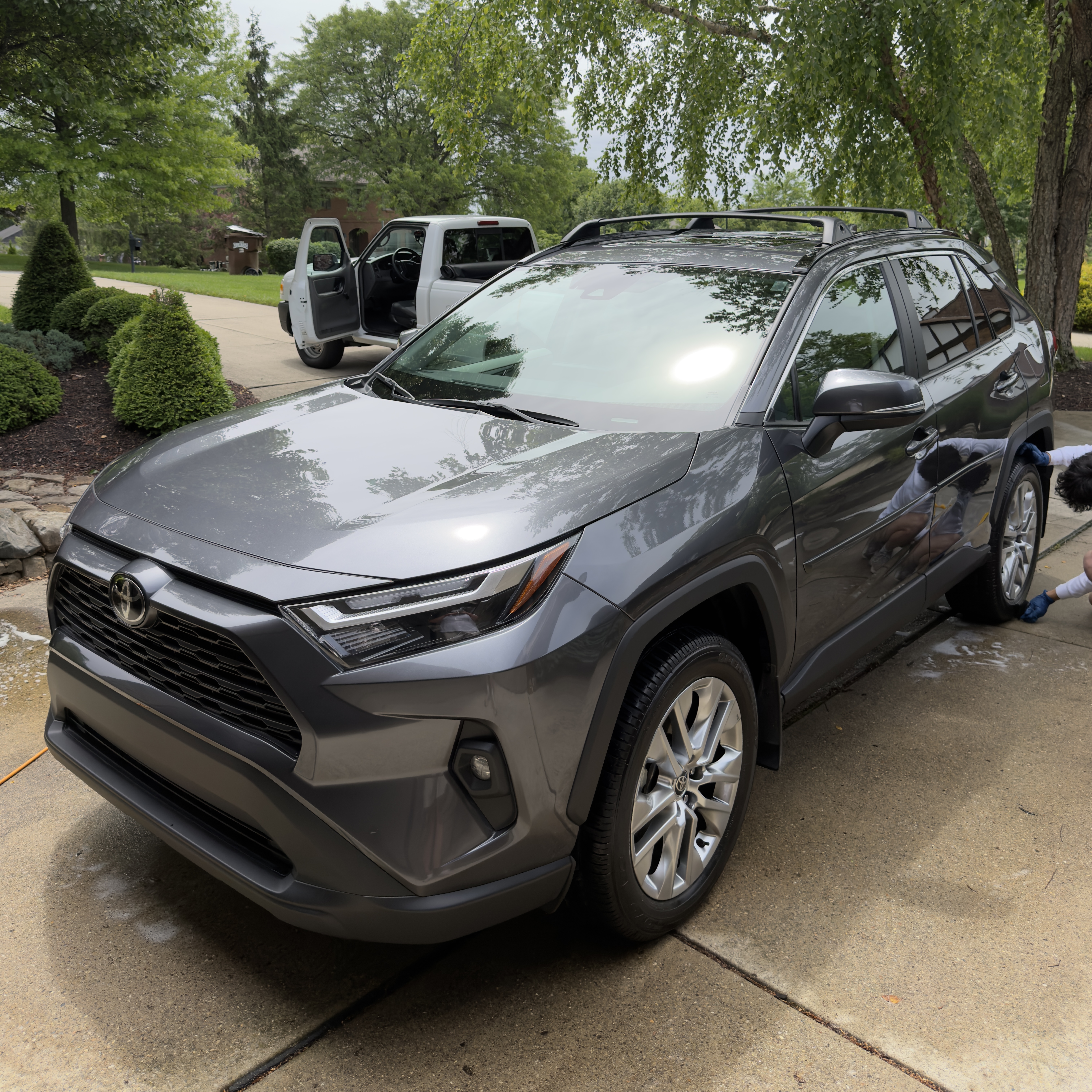 Gray Toyota RAV4 exterior being detailed in driveway